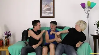 Two guys hold down and tickle an older man